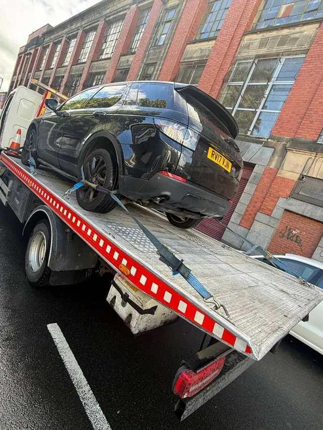 Damaged SUV secured for onward transport